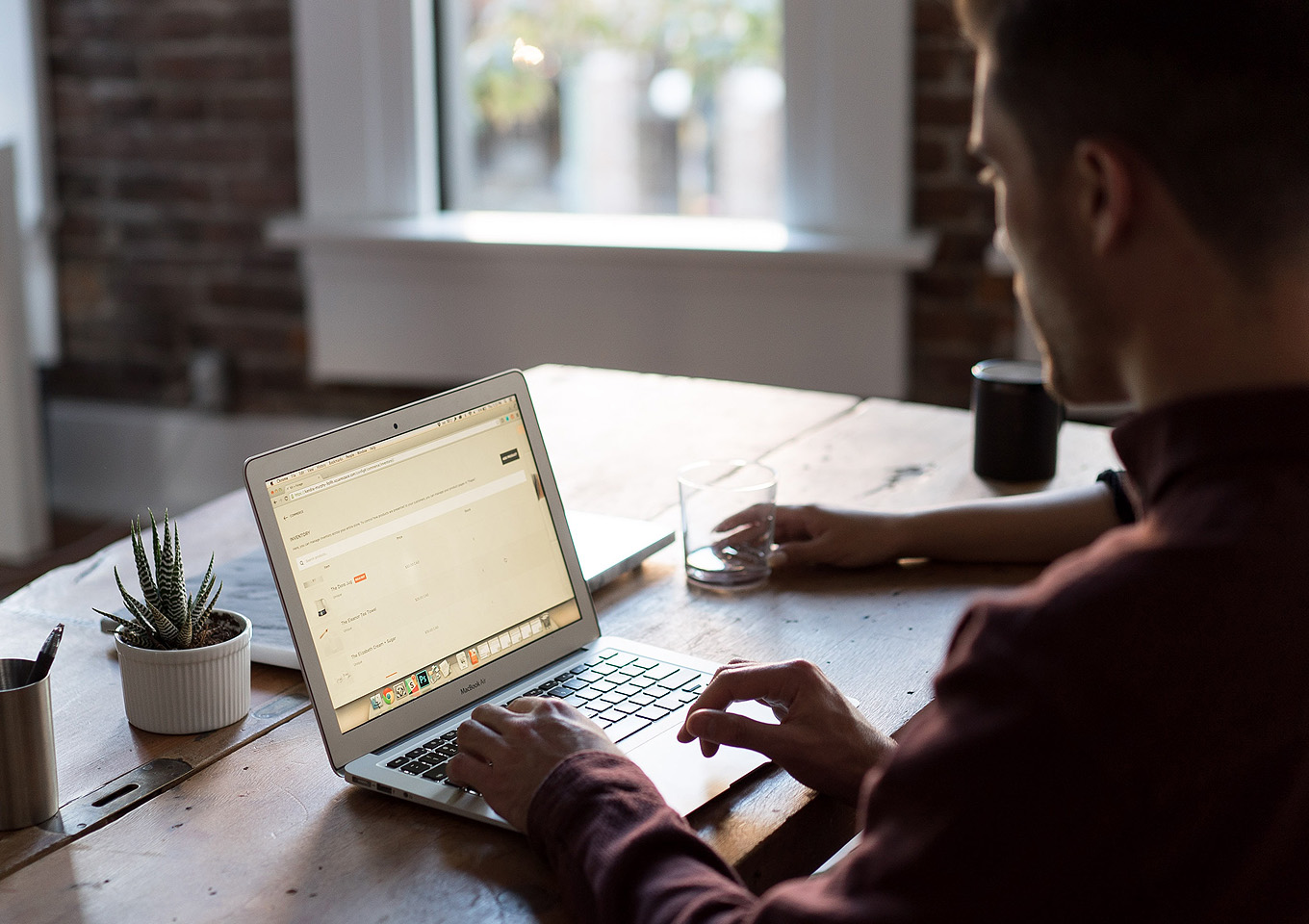 man typing on laptop